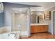 Bathroom featuring a shower, wood-look flooring, and double sink vanity at 6973 W Louisiana Ave # E, Denver, CO 80232