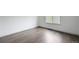 Bedroom with wood floors and bright light from a large window at 6973 W Louisiana Ave # E, Denver, CO 80232