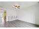 Spacious bedroom features grey wood floors, neutral walls, and a ceiling fan at 6973 W Louisiana Ave # E, Denver, CO 80232