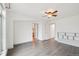 Spacious bedroom features wood-look tile floors, neutral walls, and a ceiling fan at 6973 W Louisiana Ave # E, Denver, CO 80232