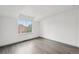 A bright bedroom features wood-look flooring and a large window at 6973 W Louisiana Ave # E, Denver, CO 80232