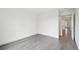 Bright bedroom features gray wood-look floors and neutral walls at 6973 W Louisiana Ave # E, Denver, CO 80232