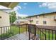 Wooden deck with dark stain and black metal railing offers outdoor relaxation space at 6973 W Louisiana Ave # E, Denver, CO 80232