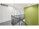 Hallway featuring wood-look floors, staircase and bright accent wall at 6973 W Louisiana Ave # E, Denver, CO 80232