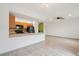 Open-concept kitchen view featuring classic wood cabinets, a breakfast bar, and modern appliances, seamlessly connecting with the living area at 6973 W Louisiana Ave # E, Denver, CO 80232