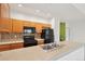 The kitchen includes stainless steel appliances, wood cabinetry, and a tile backsplash at 6973 W Louisiana Ave # E, Denver, CO 80232