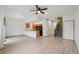 The open floorplan features laminate flooring, a ceiling fan, and a seamless flow between the living and kitchen areas at 6973 W Louisiana Ave # E, Denver, CO 80232