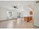 Open-concept living area with modern flooring, kitchen bar, and an abundance of natural light creating a welcoming space at 6973 W Louisiana Ave # E, Denver, CO 80232