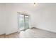 Bright living room with wood-look floors, airy curtains, and sliding glass doors that let in natural light at 6973 W Louisiana Ave # E, Denver, CO 80232