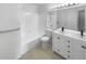 Bright bathroom featuring a double vanity, tile floors, and a combined shower and tub at 960 Milo Cir # B, Lafayette, CO 80026
