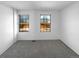 This bright bedroom features gray carpet and two windows letting in plenty of natural light at 960 Milo Cir # B, Lafayette, CO 80026