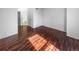 Bright bedroom featuring glossy wood floors and a door leading to the attached bathroom at 960 Milo Cir # B, Lafayette, CO 80026