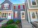 Charming townhome featuring colorful siding, red shutters, and a well-maintained front yard at 960 Milo Cir # B, Lafayette, CO 80026