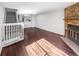 Spacious living room featuring a stone fireplace, wood floors, and staircase access at 960 Milo Cir # B, Lafayette, CO 80026
