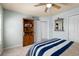 Bedroom featuring a ceiling fan, bookshelf, a mirror, and neutral color scheme for a cozy feel at 8318 Devinney Ct, Arvada, CO 80005