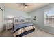 Bedroom with a nautical themed decor features coordinated blue and beige bedding and soft natural light at 8318 Devinney Ct, Arvada, CO 80005