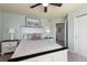 Bedroom with coordinated gray and white bedding and a ceiling fan for comfortable rest at 8318 Devinney Ct, Arvada, CO 80005