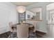 Cozy dining area featuring a round table, tufted chairs, and a view of the kitchen at 8318 Devinney Ct, Arvada, CO 80005