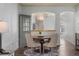 Bright dining area with modern chandelier, stylish furnishings, and view to kitchen at 8318 Devinney Ct, Arvada, CO 80005
