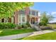 Lovely home showcasing a manicured lawn, mature trees, and a cozy front porch at 8318 Devinney Ct, Arvada, CO 80005