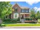 Charming two-story brick home with landscaped front yard and welcoming front porch at 8318 Devinney Ct, Arvada, CO 80005