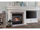 Close-up of a modern fireplace with a brick surround and built-in media storage at 8318 Devinney Ct, Arvada, CO 80005