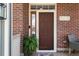 Inviting front entry with a classic door, brick facade, and charming decor at 8318 Devinney Ct, Arvada, CO 80005