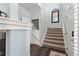 Entry hall features hardwood flooring and staircase with carpet runner and leads to the upper level at 8318 Devinney Ct, Arvada, CO 80005