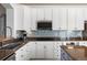Modern kitchen featuring granite countertops, stainless steel appliances, and bright backsplash at 8318 Devinney Ct, Arvada, CO 80005