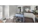 Stylish kitchen island with granite top, seating, and view to the kitchen area at 8318 Devinney Ct, Arvada, CO 80005