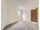 Carpeted bedroom with neutral walls, trim, and a window overlooking the yard at 2949 Shady Holw, Boulder, CO 80304