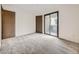 Empty carpeted bedroom with neutral walls, a closet, and a sliding glass door to the outside at 2949 Shady Holw, Boulder, CO 80304