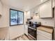 Bright kitchen featuring white cabinets, stainless steel appliances, and a view to the outside at 2949 Shady Holw, Boulder, CO 80304