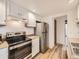 Bright kitchen with stainless steel appliances, white cabinets and wood-look flooring at 2949 Shady Holw, Boulder, CO 80304