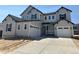 Charming two-story home with light-grey siding, black trim, an attached two-car garage, and an inviting front porch at 5500 Tamarack Ave, Firestone, CO 80504