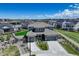 Stunning aerial view of a modern home with a well-maintained lawn in a Gathering-friendly suburban neighborhood at 22593 E Piccolo Way, Aurora, CO 80016