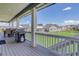 Covered patio showcasing a barbecue, views of the open green space, and neighboring homes at 22593 E Piccolo Way, Aurora, CO 80016