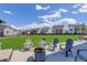 This backyard includes a fire pit and lawn chairs at 22593 E Piccolo Way, Aurora, CO 80016