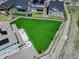 Aerial view of a home's backyard with green lawn and patio at 22593 E Piccolo Way, Aurora, CO 80016