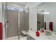 Modern bathroom featuring a glass shower and a single vanity sink at 22593 E Piccolo Way, Aurora, CO 80016