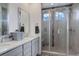 Modern bathroom featuring a glass shower and a double vanity sink at 22593 E Piccolo Way, Aurora, CO 80016