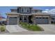 Charming two-story home with a stone and siding exterior, three-car garage, and well-manicured front yard at 22593 E Piccolo Way, Aurora, CO 80016