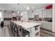 Modern kitchen with an oversized island, gray cabinetry, stainless steel appliances, and stylish backsplash at 22593 E Piccolo Way, Aurora, CO 80016