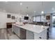 Spacious open kitchen featuring a large island, stainless steel appliances, and an open floor plan at 22593 E Piccolo Way, Aurora, CO 80016