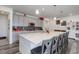 Bright, open kitchen with large island, stylish gray cabinets, and modern appliances at 22593 E Piccolo Way, Aurora, CO 80016