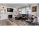 Cozy living room with fireplace, built-in shelving, and a comfortable leather sectional sofa at 22593 E Piccolo Way, Aurora, CO 80016