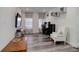 Comfortable living room featuring wood-look flooring, decor shelves, neutral walls, and an abundance of natural light at 22593 E Piccolo Way, Aurora, CO 80016