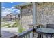 View from porch featuring stone detailing, outside seating, and a glimpse of the surrounding neighborhood at 22593 E Piccolo Way, Aurora, CO 80016