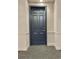 Dark wooden door, with gold numbers and hardware, contrasting with the light walls and patterned carpet at 45 N Ogden St # 201, Denver, CO 80218