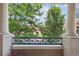 Balcony view framed by lush greenery and classic architectural columns at 45 N Ogden St # 201, Denver, CO 80218